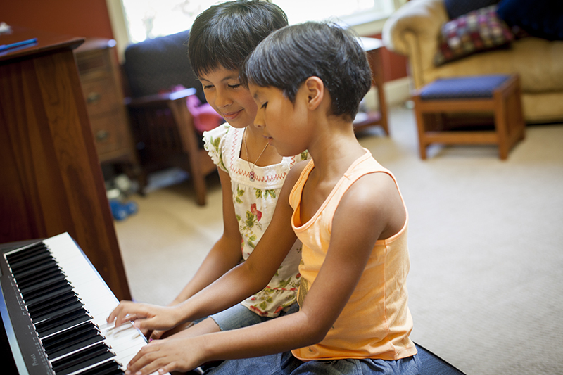 Sisters playing the piano